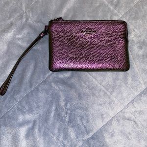 Coach wristlet color is a purple iridescent it is really beautiful!